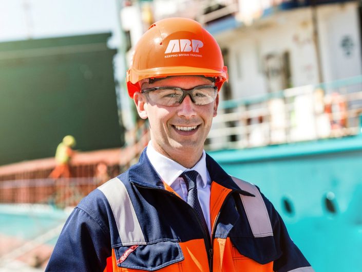 A manager from ABP photographed at Immingham docks with a ship in the background.