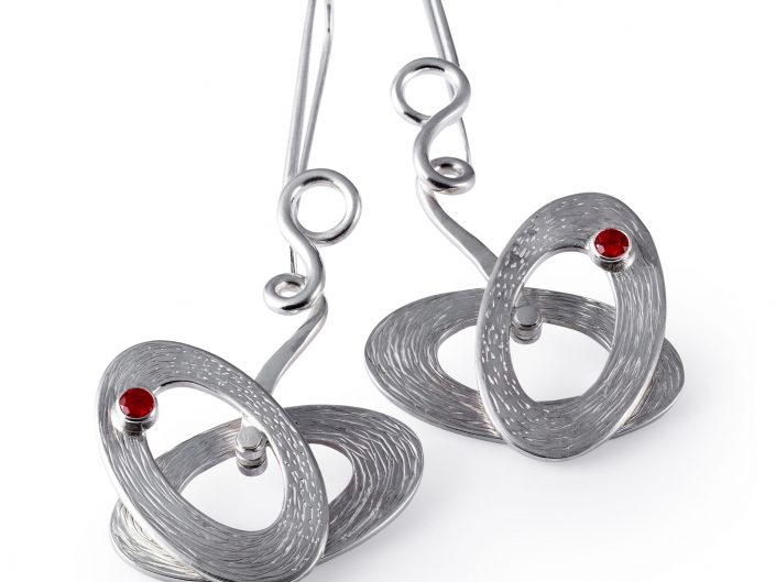 Silver earrings, Ruby Stone on a white background. Jewellery Photography, Hull, East Yorkshire.