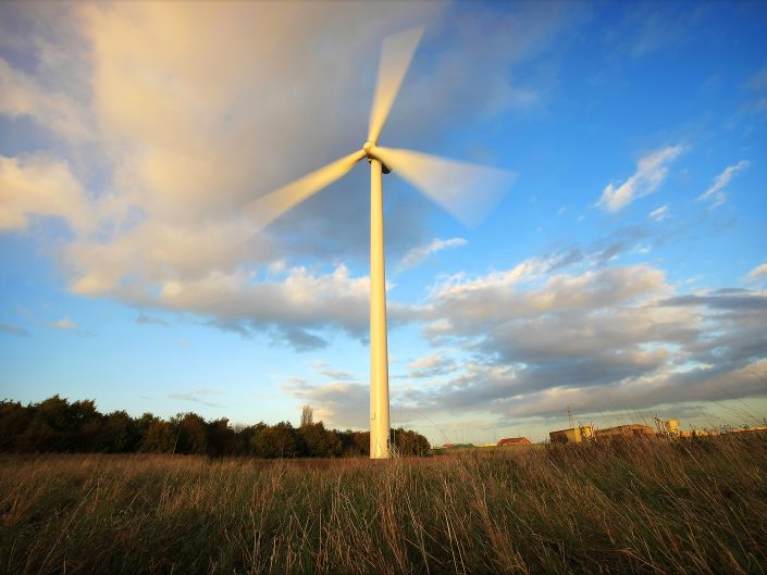 Photograph of a rotating wind turbine in a field in Yorkshire