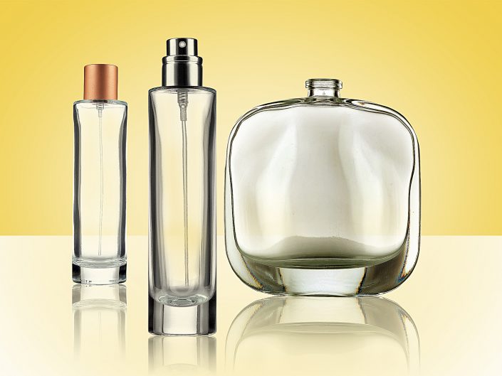 Studio product photography of Clear Glass Bottles on a Yellow Background for a Lifestyle packaging company.