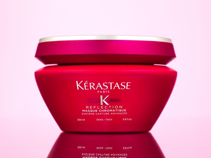 Product photograph of Kerastase K Reflection Cream packaging on a pink background for client in London.
