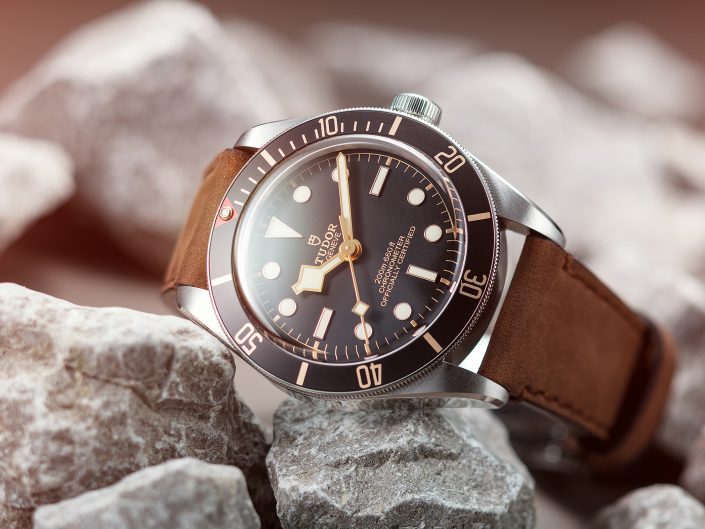 A Tudor watch with brown leather strap on photographed on Grey rocks in our East Yorkshire product photography studio.