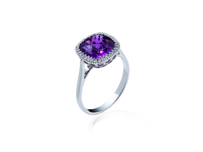 Jewellery photograph of a White Gold Ring, Purple Stone on a white background.