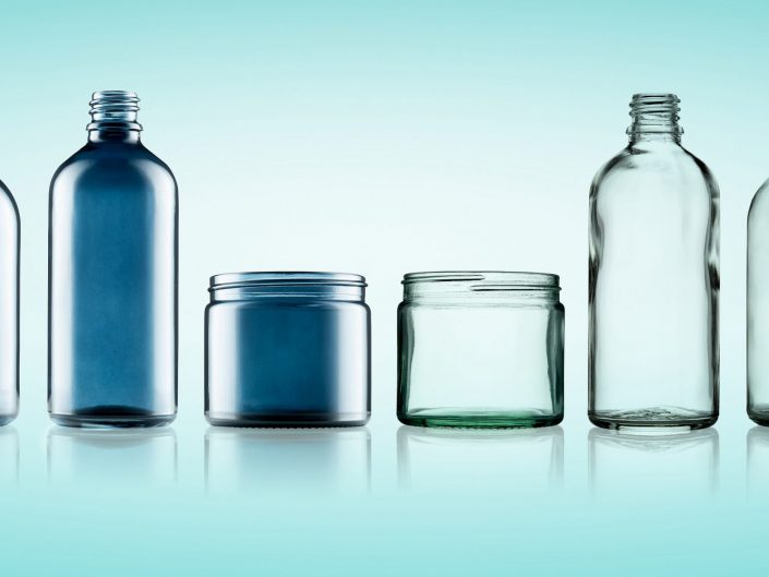 Blue Glass Bottles and Jars on a light blue backgroung. Photographed in an Willerby, East Yorkshire, Product and packaging photography studio.