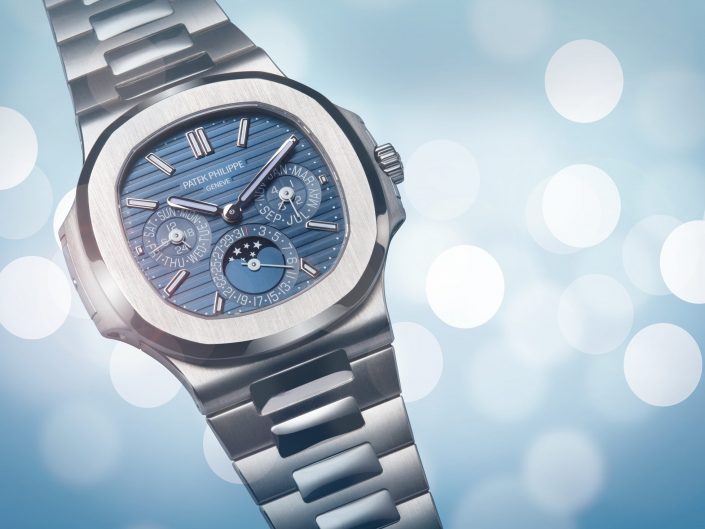 A luxury brand product photograph of a Patek Philippe watch, photographed on a blue background in our Hull studio for a magazine advert.