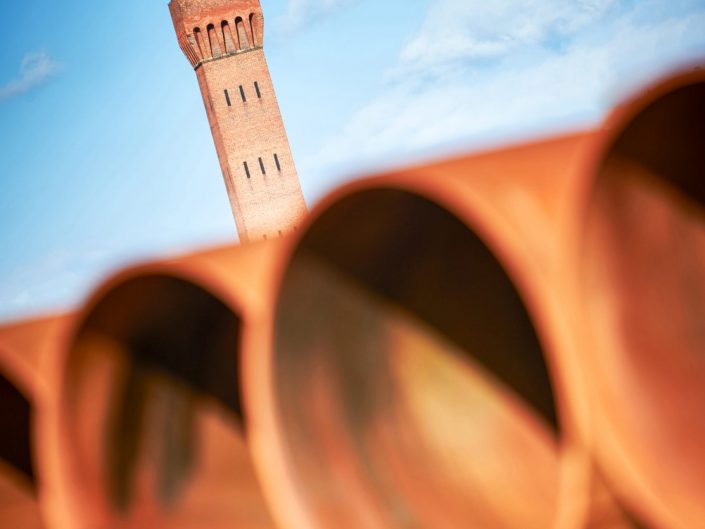 A abstract image of pipes stored on the docks with the Grimsby Tower in the background.